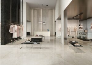 clothing shop with minimalist display set against contrasting dark wall tile surrounded by tiled pearl coloured floor and walls
