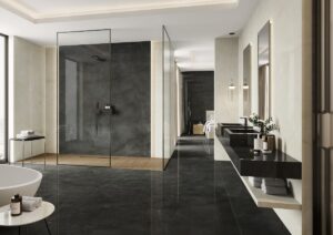 bathroom with contrasting light and dark tiled surfaces, dark floor, cream walls and dark stone effect counter and basin