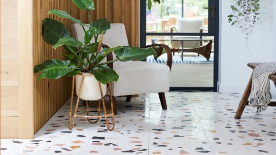 entrance hall with chair and plant and Bert & May course terrazzo style tiles on the floor