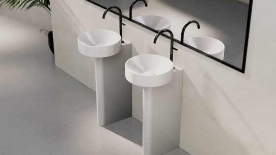 two white round BetteSuno basins side by side with black taps in front of large mirror