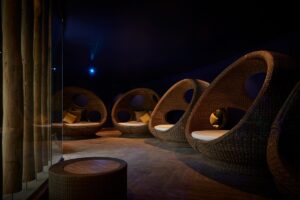 atmospheric lighting in the nest in the spa with hanging basket chairs for guests