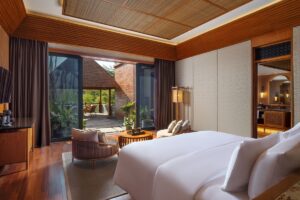 guestroom at Garrya Bianti Yogyakarta with view across bed to terrace and ensuite bathroom