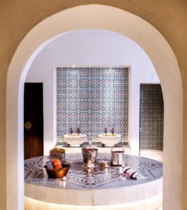 arched entrance into the traditional hammam space with decorative tiled detail in The Residence Douz Tunisia