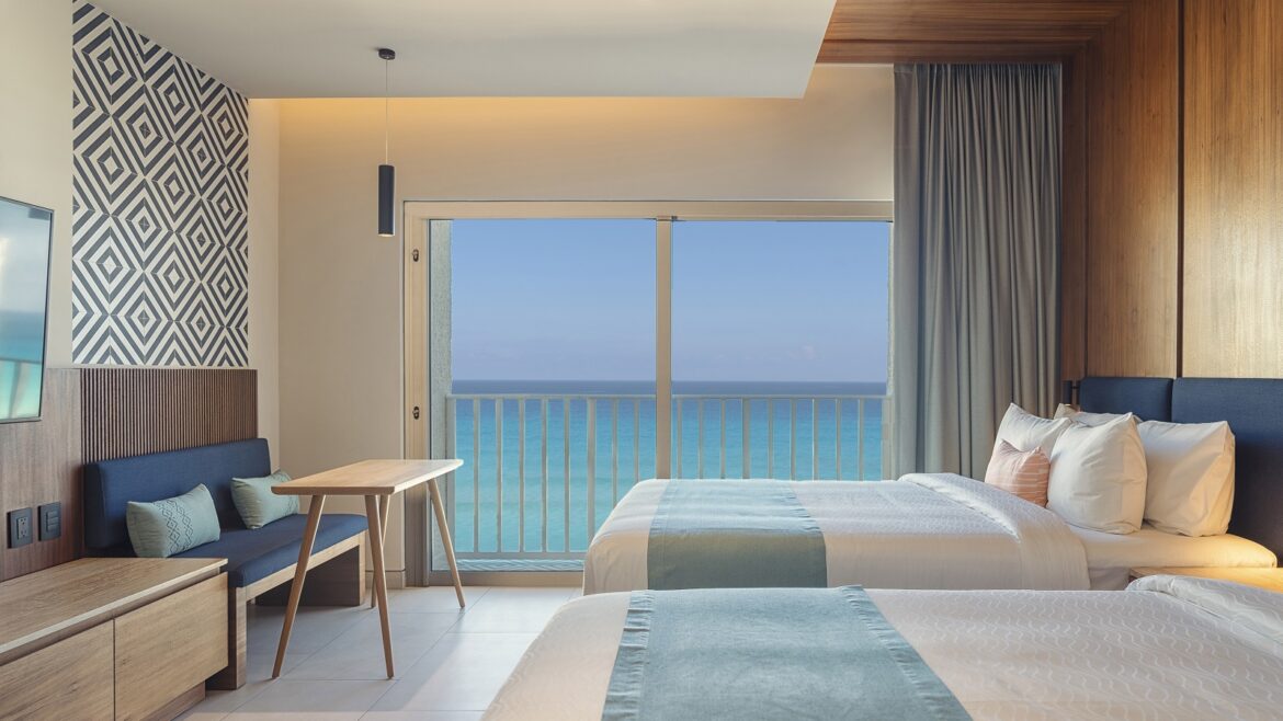 https://hoteldesigns.net/wp-content/uploads/2023/10/Hilton-Cancun-Mar-Caribe-All-Inclusive-Resort-Double-Bed-Balcony-Beachfront-1170x658.jpg