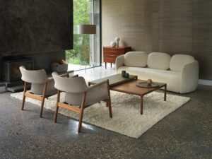 Bilbao cream couch by Morgan in lounge setting with wooden coffee table wooden chairs and cream rug in front of fireplace