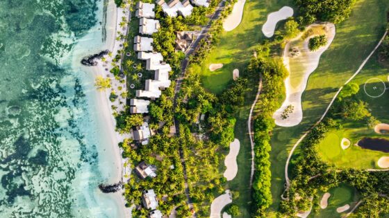Arial view of Paradis Beachcomber in Mauritius. The image shows both above-shots of villas and the clear blue sea