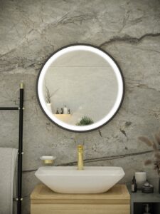 round bathroom mirror above square basin on marble tiled wall