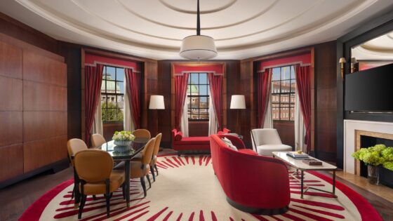 circular red and white carpet, red walls and central bespoke light by Northern Lights in Raffles London OWO Atkins Suite lounge