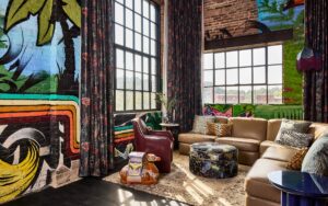 guest suite at The Radical with graffiti on the walls contrasted with vintage floral fabric dressing the windows
