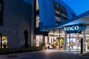 evening lights in lobby and signage of voco Brussels