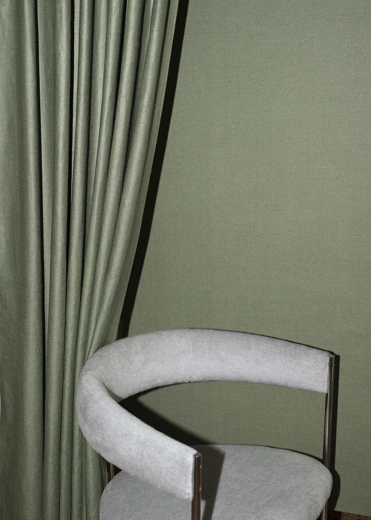 green dedar wallcovering and fabric and white chair