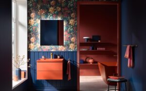 dark orange basin and vanity by Duravit against blue wood panelling and floral wallpaper