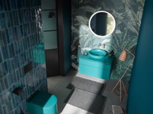 teal blue bathroom fittings, glossy blue tiles and a blue jungle print wallpaper in small guest bathroom
