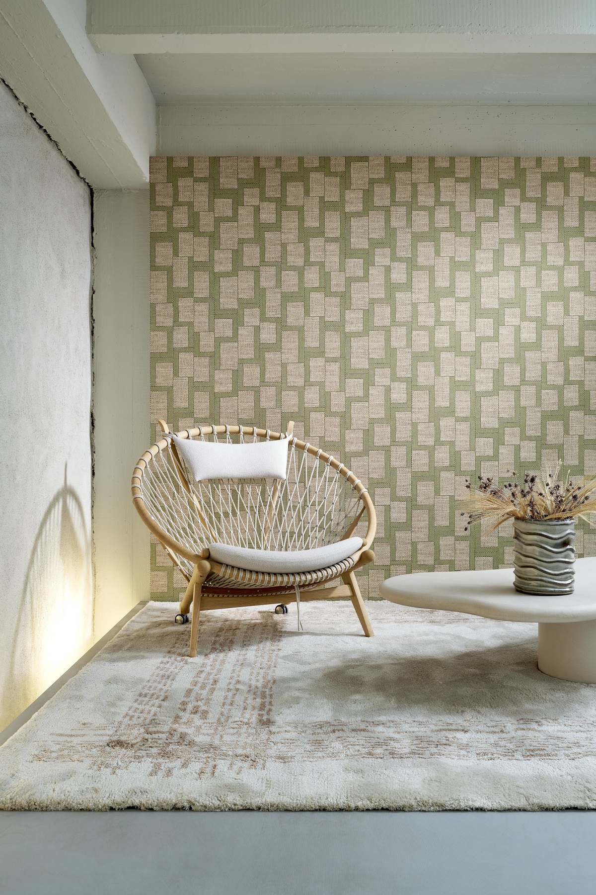 hessian inspired wallcovering behind wicker globe chair
