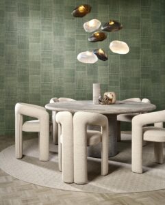 curved organic dining chairs and table with lights above and textured wallcovering behind
