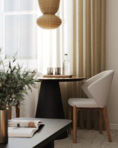 woven lampshade over round table and contemporary chair in front of window