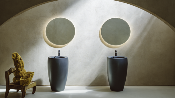 two round wall mirrors above two frreestanding basin units from Laufen