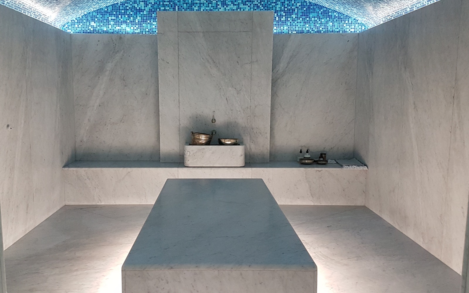 heated stone treatment bed with blue mosaic ceiling in The Newt