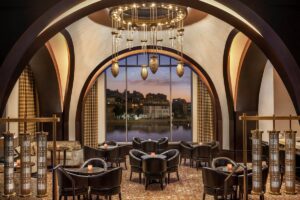 seating in arched lobby space under lighting feature and in front of large arched window in St Regis Cairo