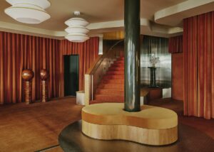 terracotta curtains, wooden floors and graphic shapes and lightfittings in the Locke lobby