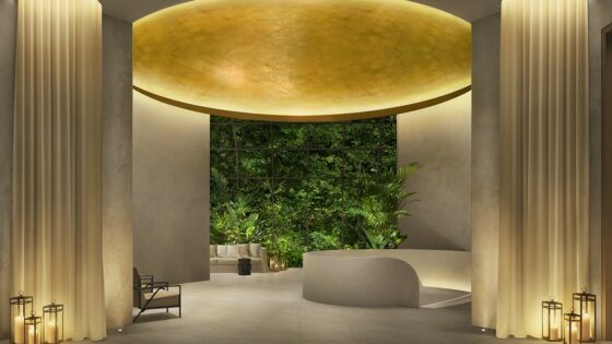 gold vaulted ceiling in the cream lobby with planted wall in The Singapore EDITION