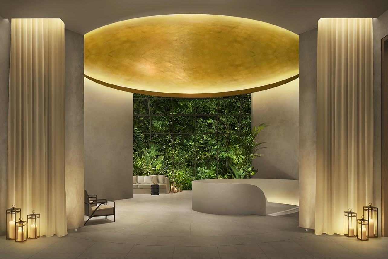 gold vaulted ceiling in the cream lobby with planted wall in The Singapore EDITION
