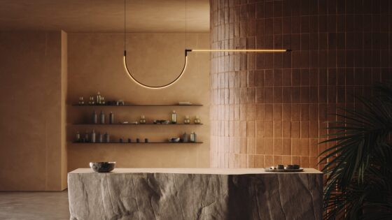 stone counter in front of brown tiled wall with architectural tubular lighting above from LedsC4