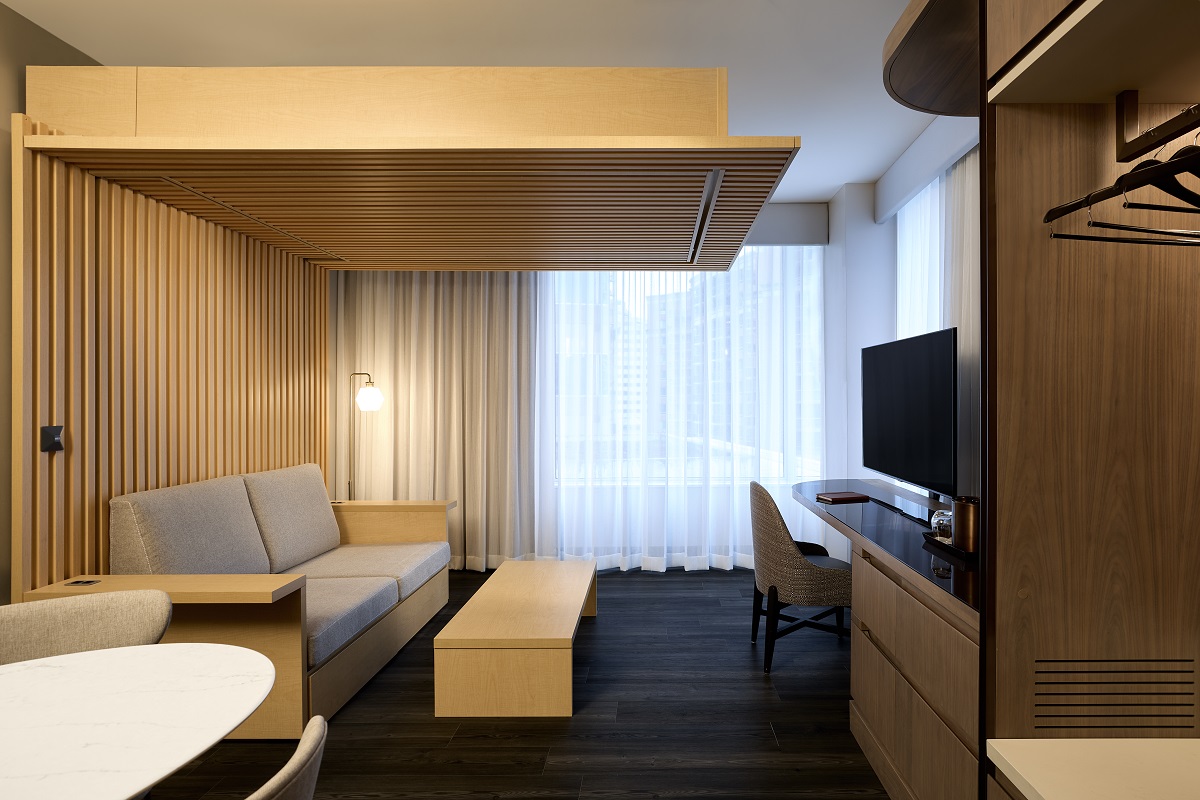 A suite that has a bed, in a wooden frame, in the ceiling 