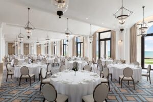 diamond patterned carpet, formal table settings and glass lanterns in the astor Ballroom at St Regis Tamuda Bay