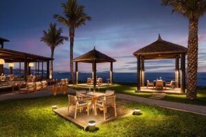 outdoor cabana seating alongside pool bar with seaviews