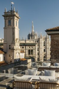 rooftop terrace and bar overlooking historic buildings in Milan