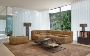 glass walls, brown carpet and brown quilted ligne roset Kashima sofa