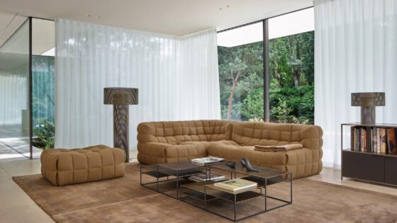 glass walls, brown carpet and brown quilted ligne roset Kashima sofa