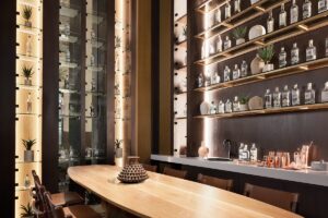 shelving with mezcal collection behind a table in JW Marriott Polanco