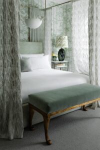 four poster bed with porcelain bird light fitting