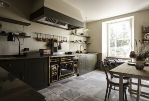 traditional black oven and wooden table in a country kitchen