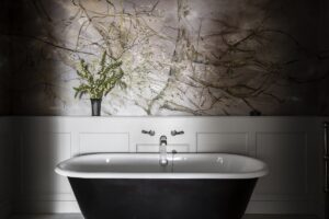 slipper bath in front of a hand painted wall