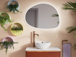 oval bathroom mirror with wall plants and a terracotta basin unit