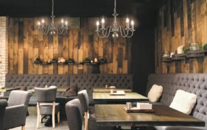 chandelier lighting against distressed wood walls in Mondrian restaurant