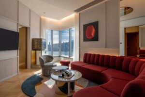 red couch in guestroom in Mondrian Hong Kong with view over harbour