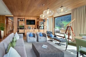 alpine wooden details and comfortable couch and telescope for mountain views