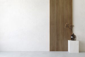 White interior with wooden wall panel and decor. Column with glass vase