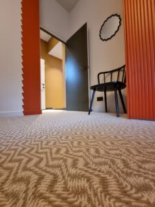 blue door and orange wall with patterned wool carpet from Flooring by Nature