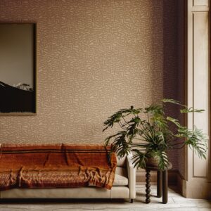couch with monstera plant in front of Arte Lanai wallcovering