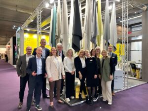 the Edmund Bell team at Heimtextil in front of stand with fabrics behind