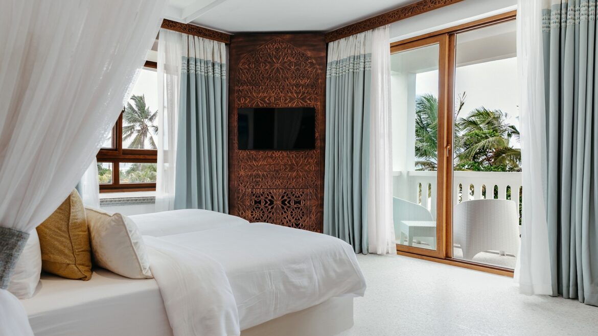 guestroom with doors leading onto balcony at LUX* Marijani