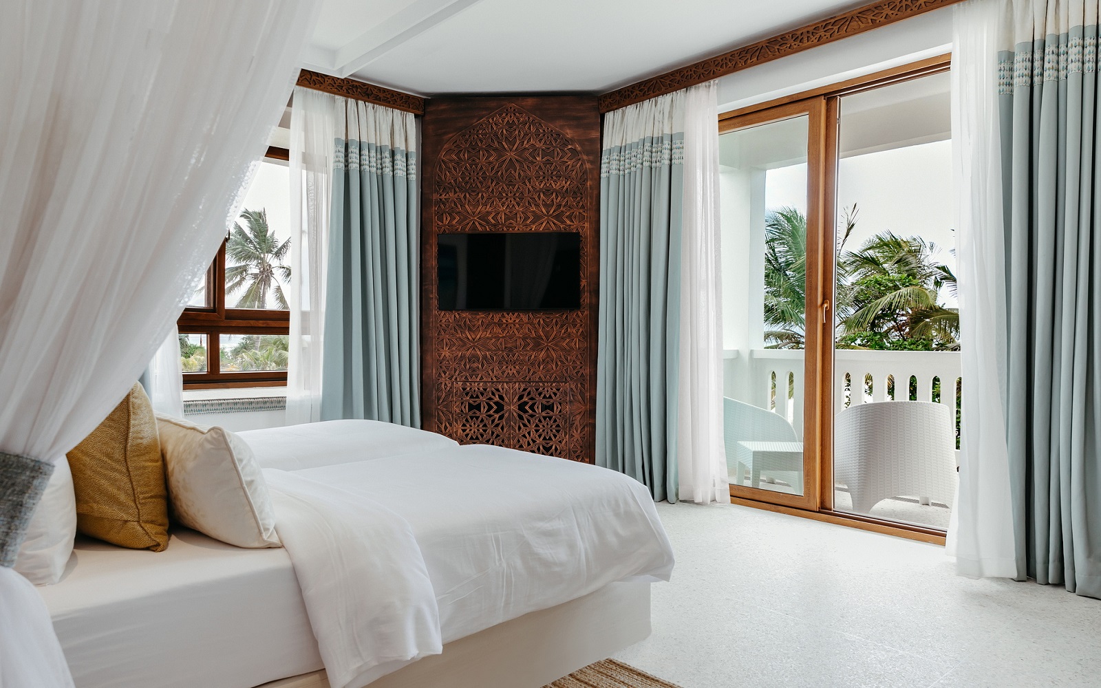 guestroom with doors leading onto balcony at LUX* Marijani