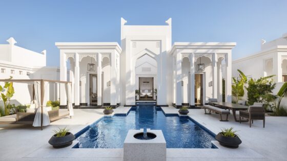 white facade and courtyard with pool at Raffles Al Areen Palace Bahrain