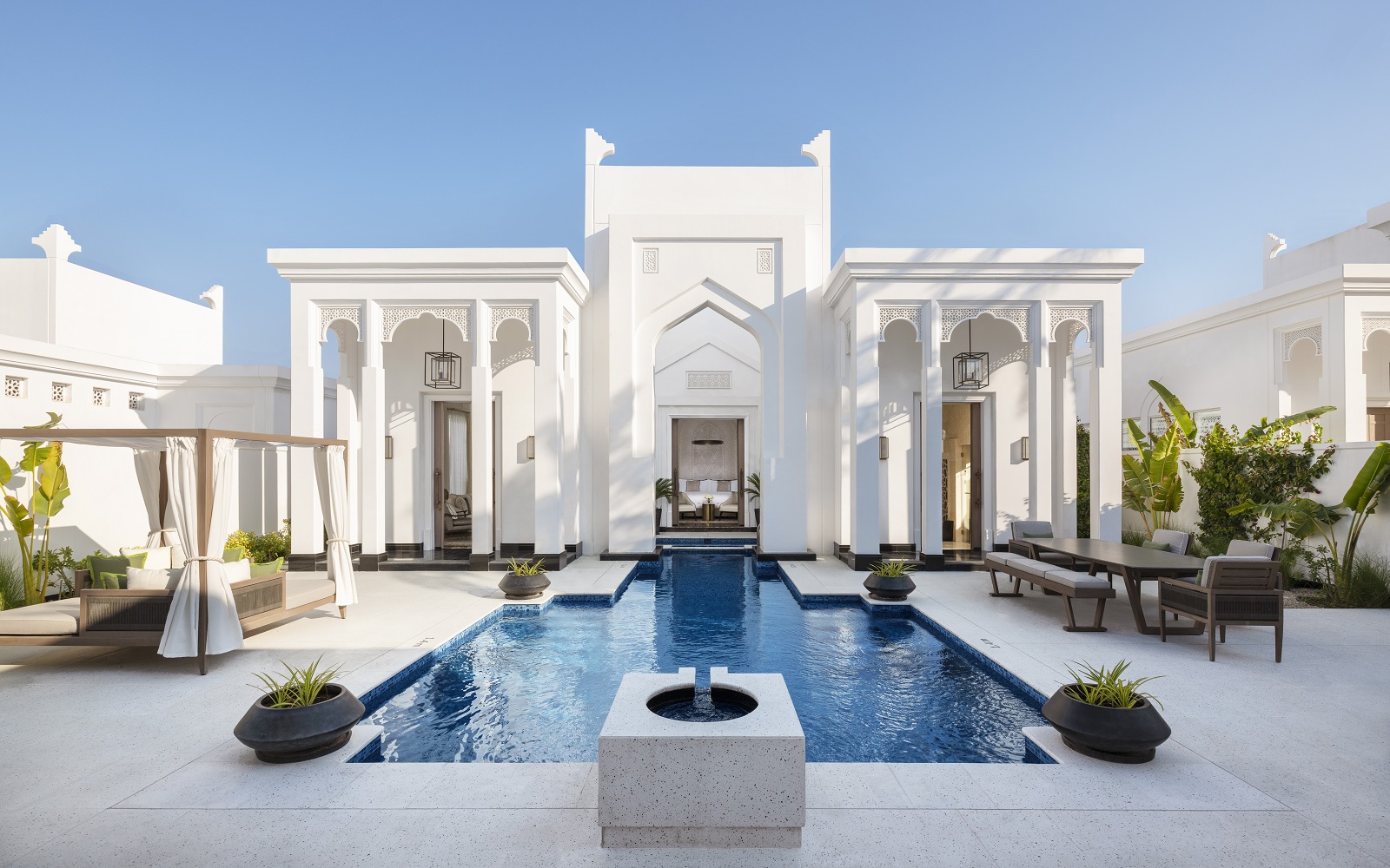 white facade and courtyard with pool at Raffles Al Areen Palace Bahrain