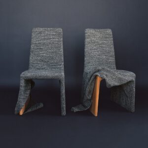 textured grey Withering Wind fabric from Dedar covering a wooden frame chair
